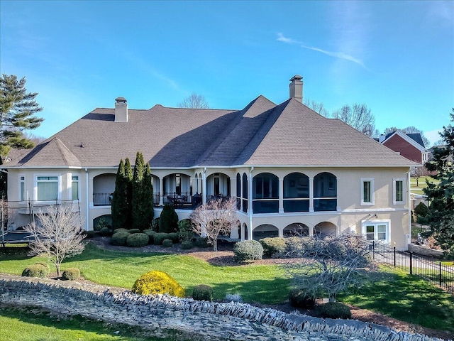 rear view of property with a lawn