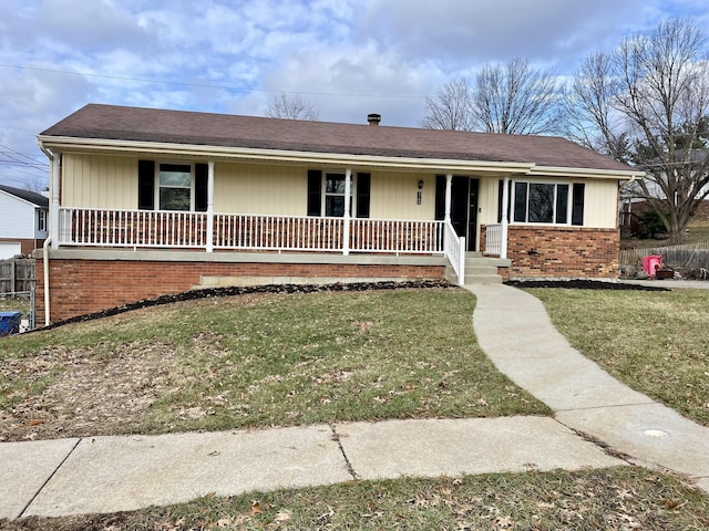 ranch-style home with covered porch and a front yard