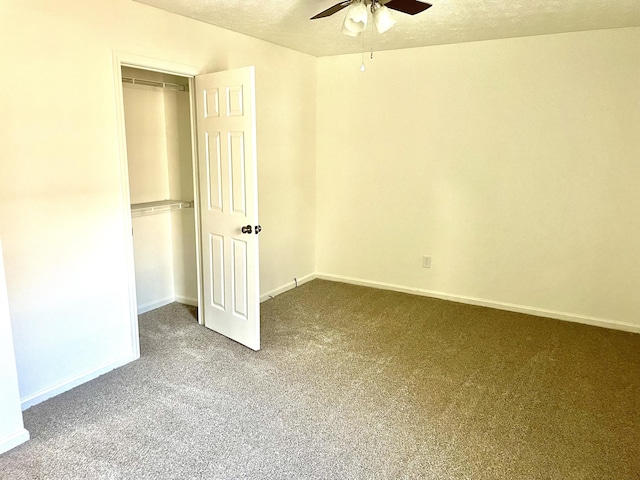 unfurnished bedroom featuring baseboards, ceiling fan, a textured ceiling, carpet floors, and a closet