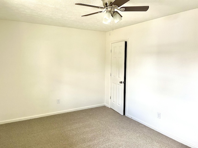 carpeted empty room featuring ceiling fan, baseboards, and a textured ceiling