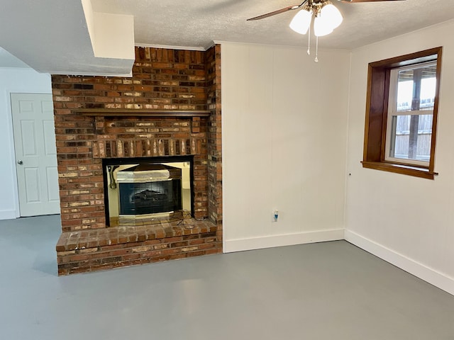 unfurnished living room featuring finished concrete flooring, a brick fireplace, baseboards, and a textured ceiling