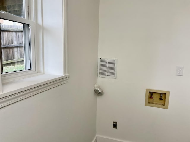 laundry room with hookup for an electric dryer, laundry area, washer hookup, visible vents, and baseboards