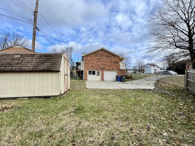 back of property featuring a storage shed, a lawn, fence, an outdoor structure, and brick siding