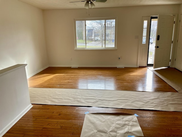 entrance foyer featuring ceiling fan, hardwood / wood-style flooring, and baseboards