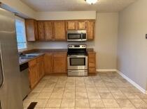 kitchen with light tile patterned floors and appliances with stainless steel finishes