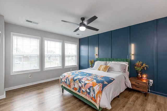 bedroom with ceiling fan and dark wood-type flooring