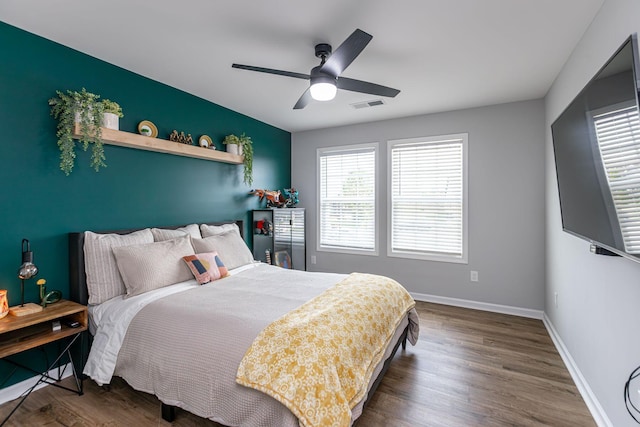 bedroom with ceiling fan and dark wood-type flooring