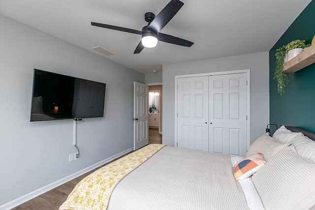 bedroom featuring dark hardwood / wood-style flooring, ceiling fan, and a closet