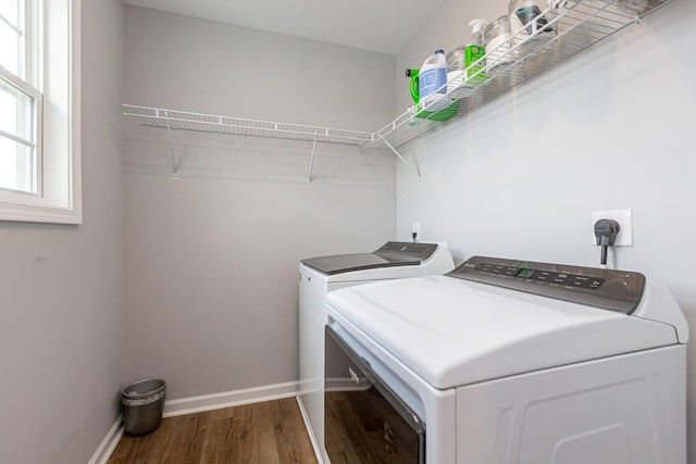 clothes washing area with independent washer and dryer and hardwood / wood-style floors