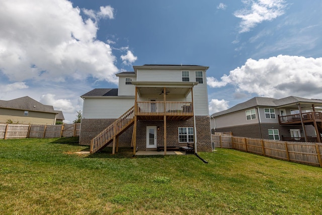 rear view of house with a lawn, ceiling fan, a deck, and a patio