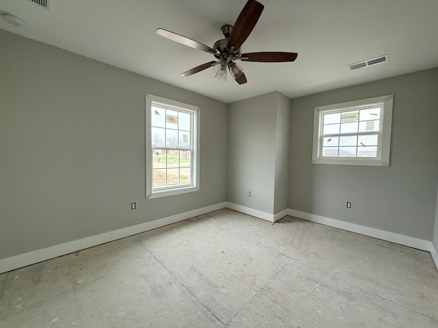 empty room featuring ceiling fan and a healthy amount of sunlight