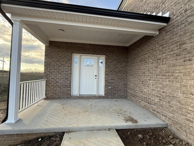 exterior entry at dusk with covered porch