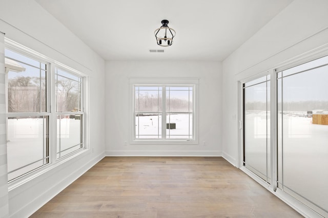 interior space featuring plenty of natural light and light hardwood / wood-style flooring