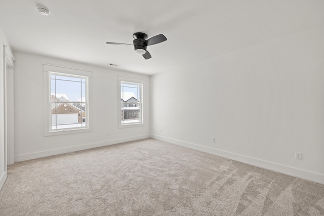 unfurnished room with light carpet and ceiling fan