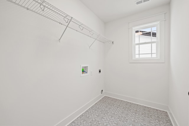 washroom featuring hookup for a washing machine, light tile patterned floors, and electric dryer hookup