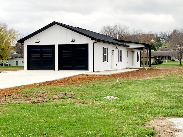 view of front of property with a garage, a porch, and a front yard