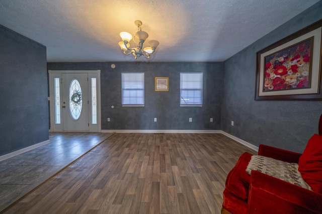 1280 Woodbury Loop, Morgantown, KY 42261 - entrance foyer with a textured ceiling, dark hardwood / wood-style flooring, and a notable chandelier