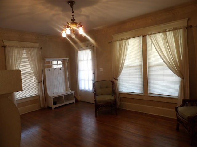 unfurnished room with dark hardwood / wood-style floors and a chandelier