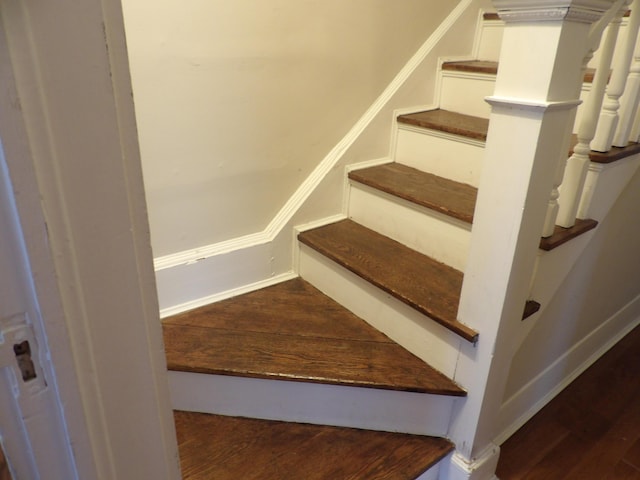 staircase with hardwood / wood-style flooring