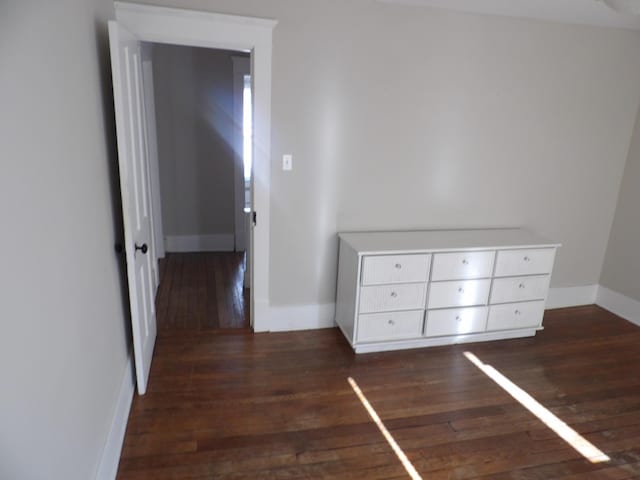 unfurnished bedroom featuring dark hardwood / wood-style flooring