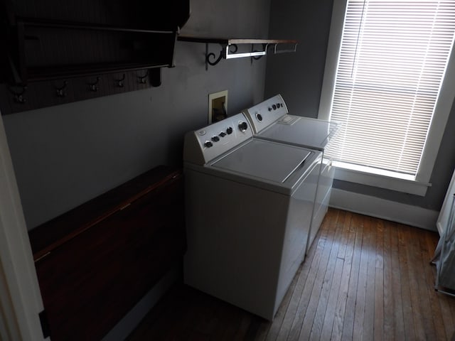 washroom featuring dark hardwood / wood-style flooring and washing machine and clothes dryer