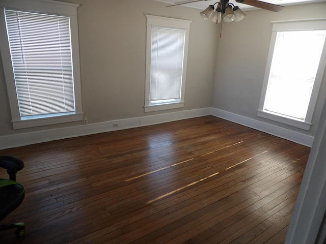 unfurnished room featuring ceiling fan and dark hardwood / wood-style flooring