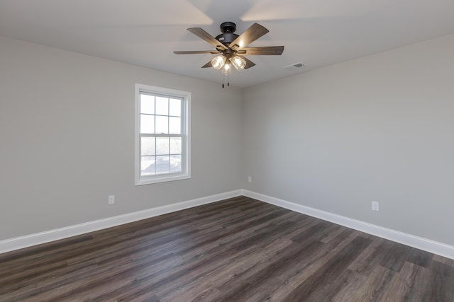 spare room with ceiling fan and dark wood-type flooring