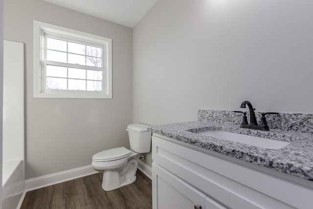 bathroom with hardwood / wood-style floors, vanity, and toilet