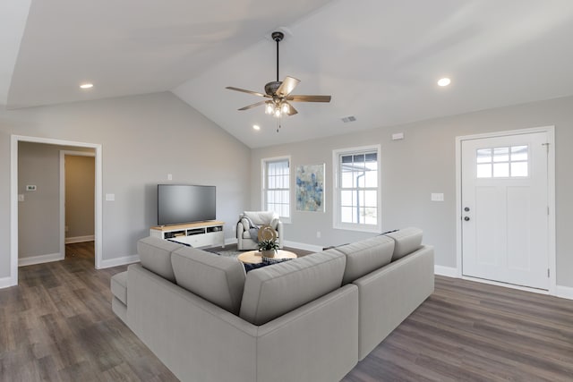 living room featuring vaulted ceiling, ceiling fan, and dark wood-type flooring