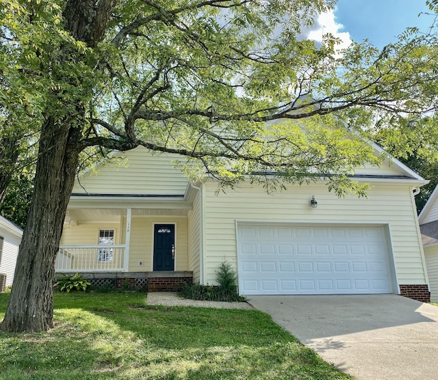 view of front facade featuring covered porch, a garage, and a front yard