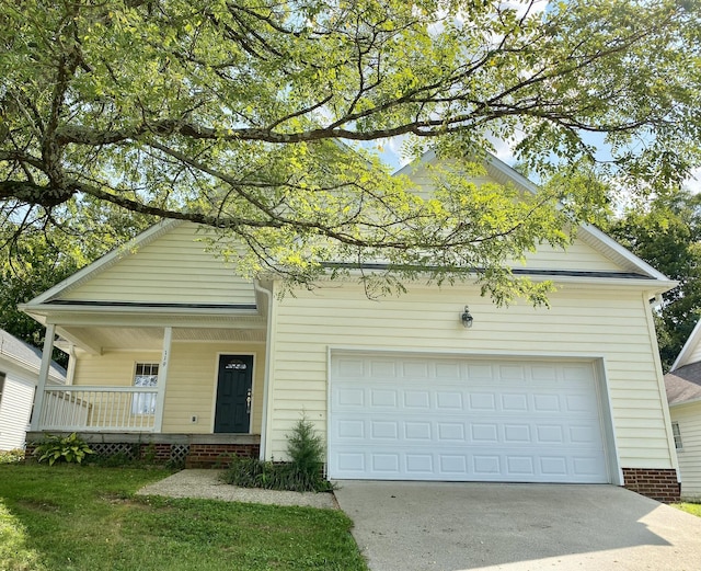 view of front of home featuring covered porch and a garage