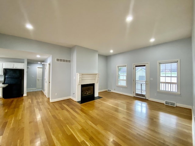 unfurnished living room featuring light hardwood / wood-style flooring