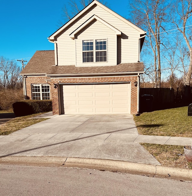 view of property with a front lawn and a garage