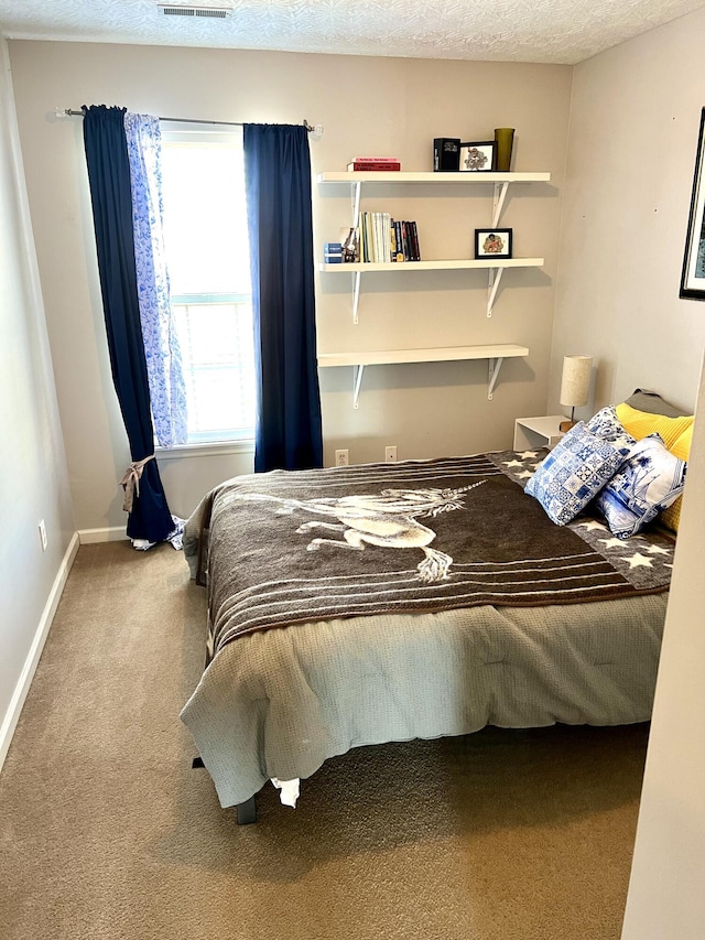 carpeted bedroom with a textured ceiling