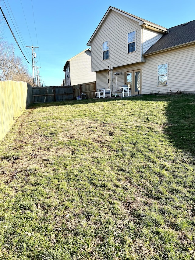 rear view of house with a yard