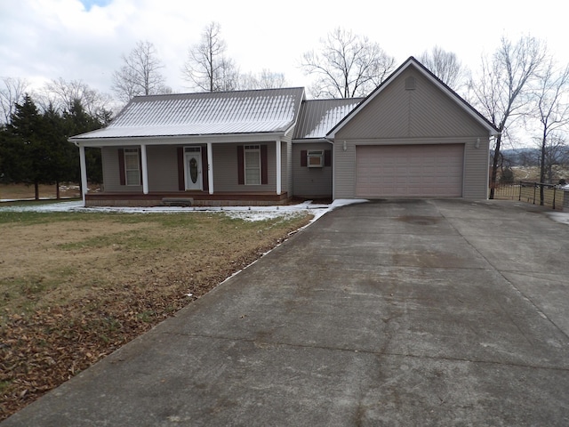 view of front facade featuring covered porch, a front yard, and a garage