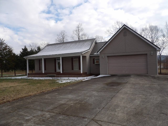 view of front facade featuring covered porch and a garage