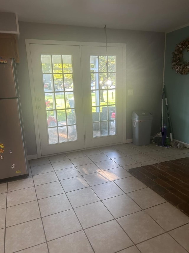 doorway with light tile patterned floors