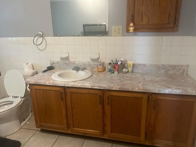 bathroom with tile patterned flooring, vanity, and toilet