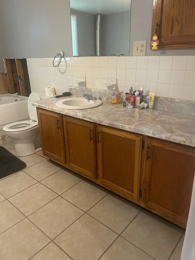 bathroom with tile patterned flooring, decorative backsplash, vanity, and toilet