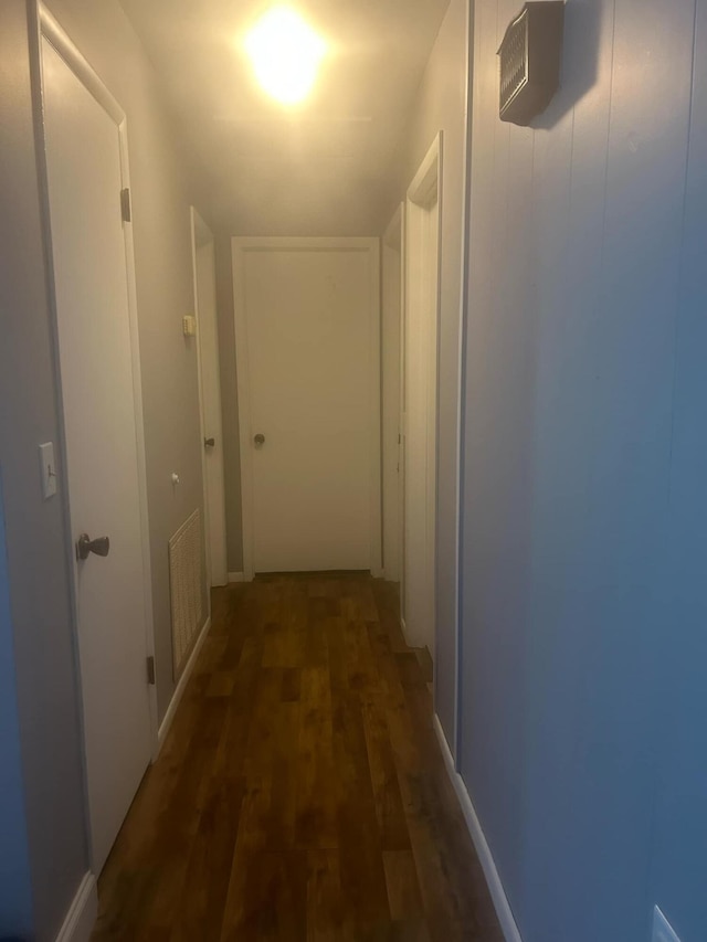 hallway with dark hardwood / wood-style floors