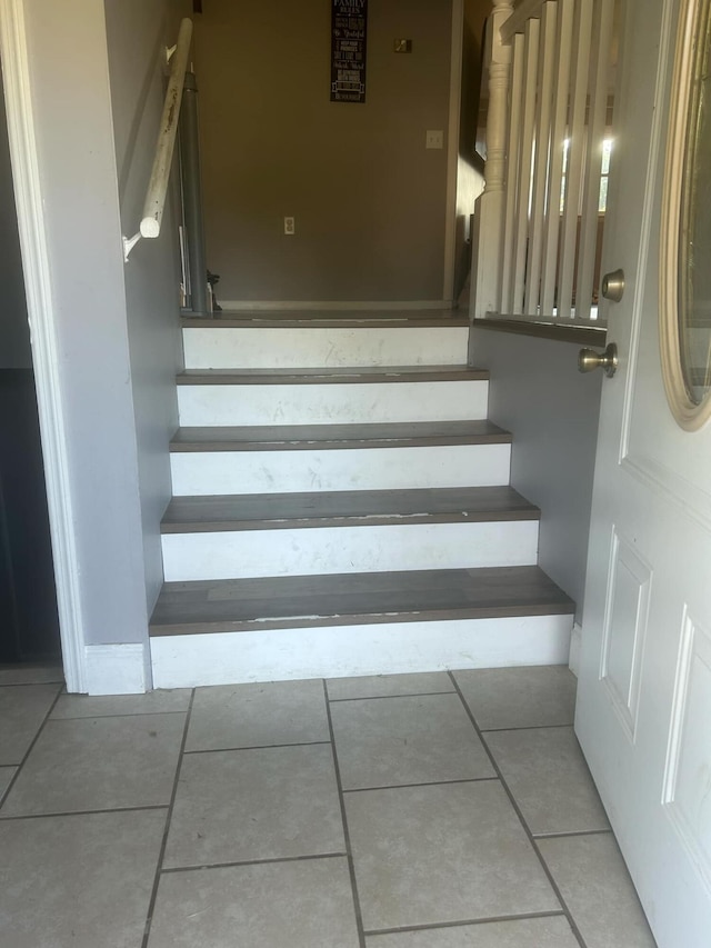 stairs with tile patterned flooring