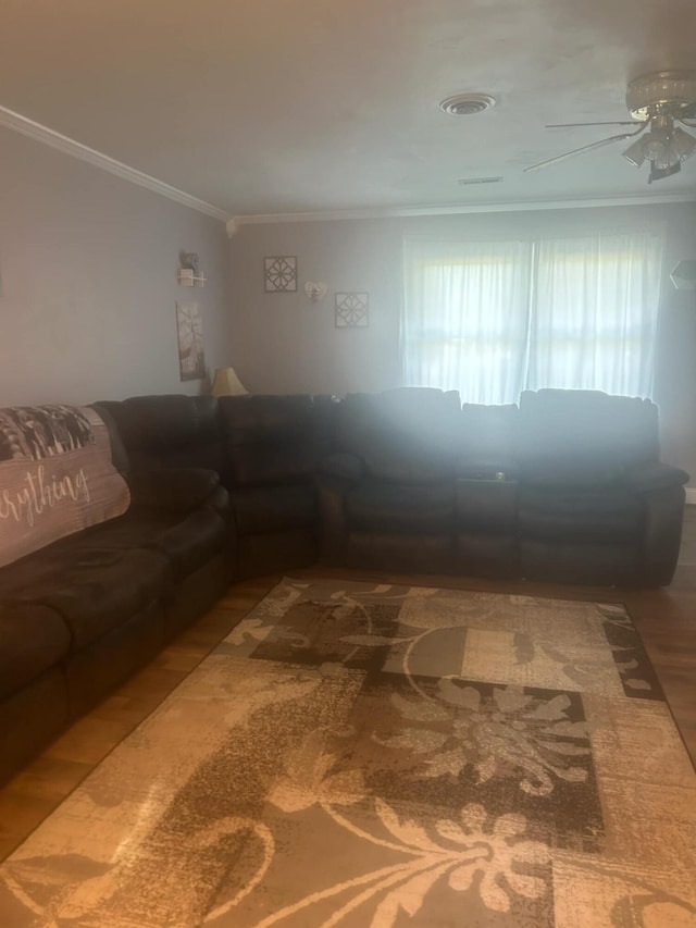 unfurnished living room with hardwood / wood-style floors, ceiling fan, and crown molding