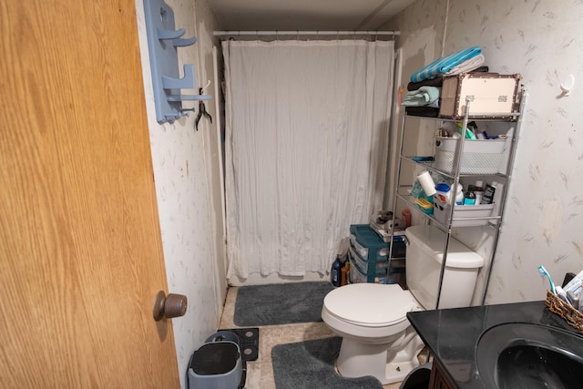 bathroom featuring vanity, toilet, and walk in shower