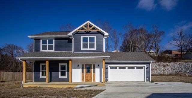 view of front of house featuring a porch and a garage