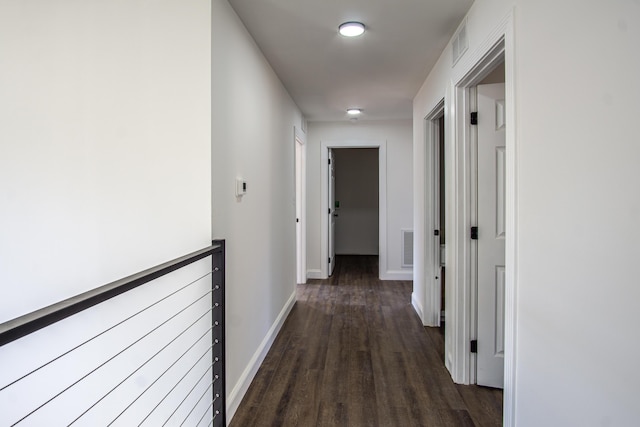 hallway with dark hardwood / wood-style flooring