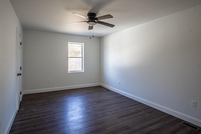 empty room with ceiling fan and dark wood-type flooring