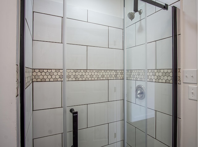 bathroom featuring a shower with shower door