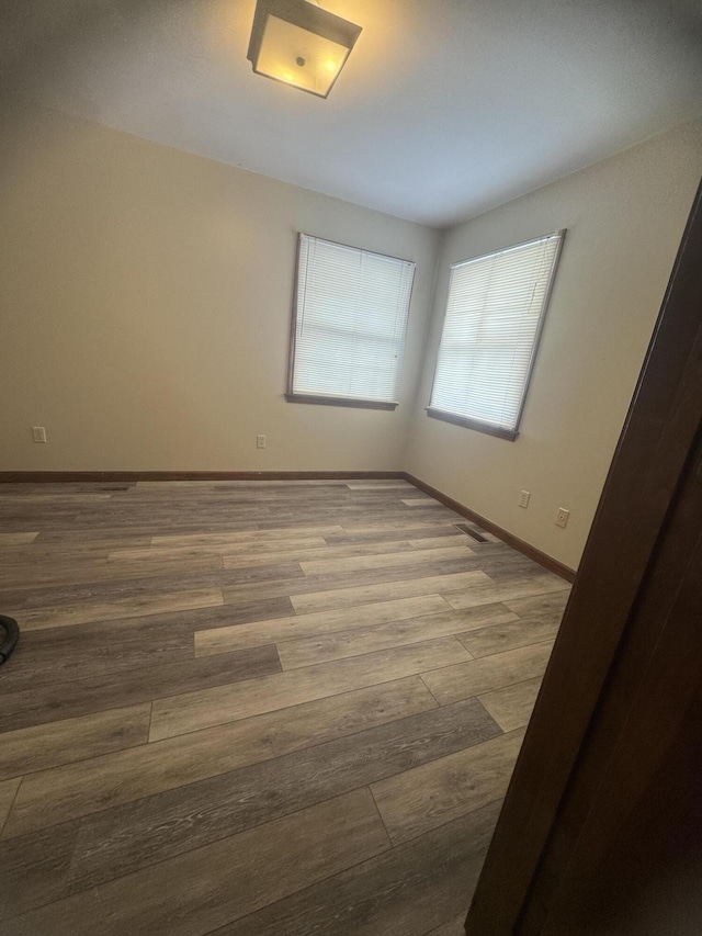 spare room with hardwood / wood-style floors