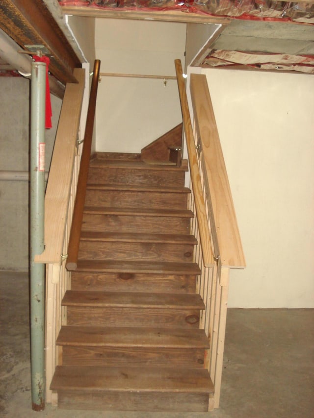 stairway featuring concrete flooring